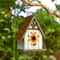 Glitzhome® 8.25" Distressed Metal Roof & Flower Wood Birdhouse